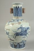A CHINESE BLUE, WHITE AND UNDERGLAZE RED PORCELAIN VASE, with warriors on horseback, 32cm high.