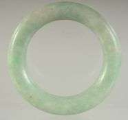 A SMALL ANTIQUE CHINESE JADEITE BANGLE, 6cm diameter.