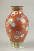 A FINE CHINESE COPPER RED GROUND FAMILLE ROSE PORCELAIN VASE