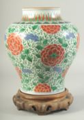 A FINE AND LARGE CHINESE POLYCHROME PORCELAIN JAR, painted with large flower heads in red amongst