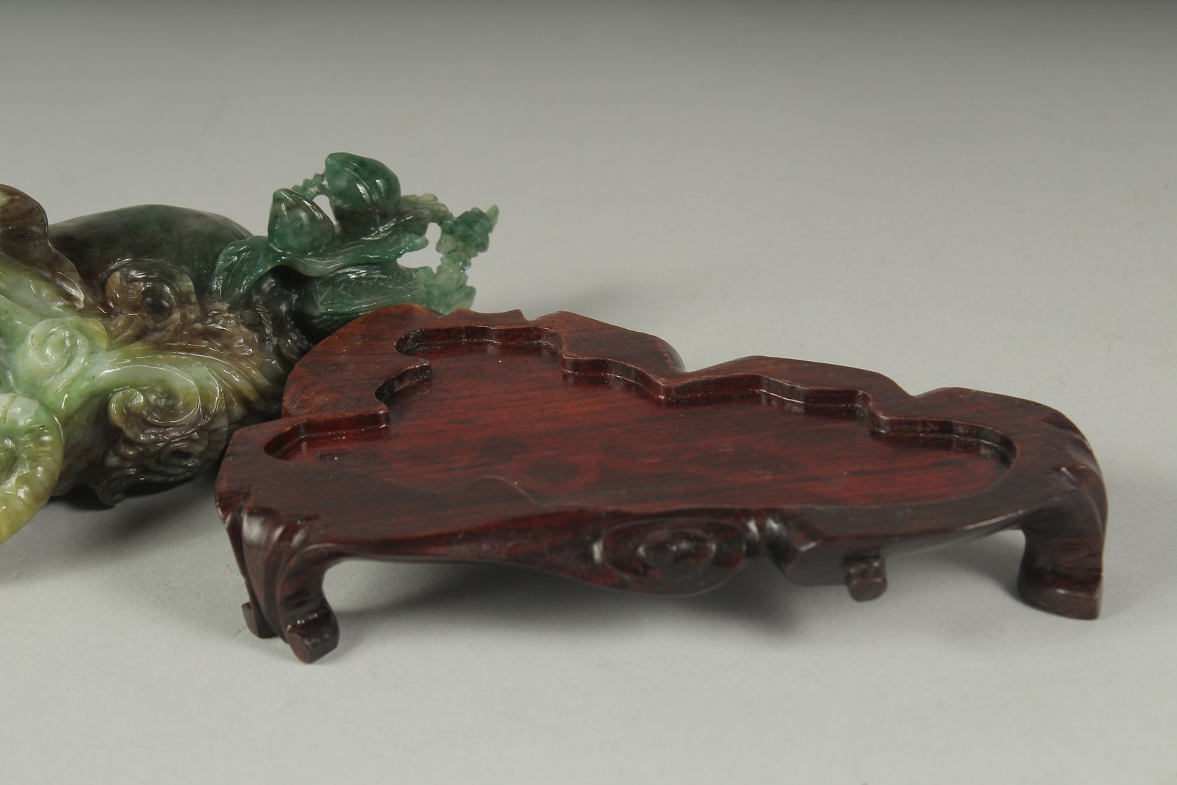 A CHINESE CARVED JADE FIGURE OF AN ELEPHANT ON A FITTED CARVED HARDWOOD STAND, figure 14cm long. - Image 4 of 4