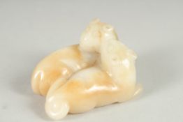 A FINE CHINESE CARVED JADE FIGURE OF TWO LIONS, 6.5cm at widest point.