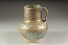 A RARE 12TH CENTURY PERSIAN KASHAN TURQUOISE GLAZED JUG, with traces of iridescence, 19cm high.