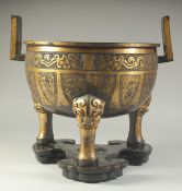 A LARGE AND HEAVY CHINESE GILT BRONZE TRIPOD CENSER, on fitted hardwood stand, censer with twin