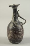 A RARE EARLY ISLAMIC OR POSSIBLY ROMAN AUBERGINE GLASS JUG, 16cm high.