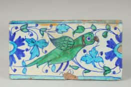 A FINE 18-19TH CENTURY MUGHAL NORTH INDIAN MULTAN TILE WITH PARROT DESIGN, 29cm x 15.5cm.