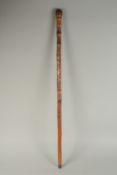 A CHINESE BAMBOO WALKING STICK, carved with bird, dragon, and a female figure, 89cm long.