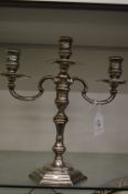 A cast silver three light twin branch candelabra with detachable top section.