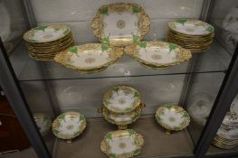 A comprehensive gilt, green and cream decorated porcelain dessert service.