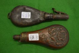 A copper powder horn and a leather shot flask.