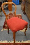 A set of four Victorian walnut balloon back dining chairs.