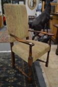 A set of six oak framed dining chairs, two with arms, all with upholstered backs and seats.