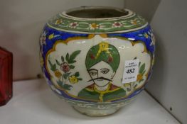 An Islamic Persian Kashgar pottery bowl painted with panels depicting busts of men.