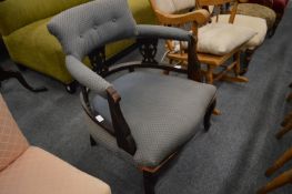 A Victorian horseshoe shaped armchair.