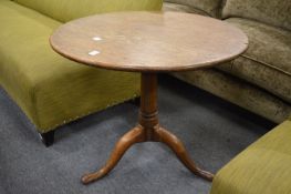 A 19th century oak tilt-top tripod table with bird cage action.