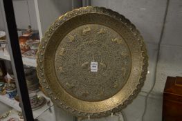 An embossed Eastern metal charger.