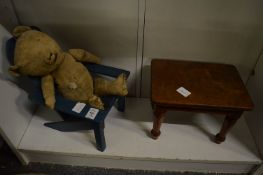 A blue painted miniature wooden armchair, a small table or stool and an old teddy bear.