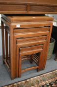 A Chinese red wood nest of four tables.