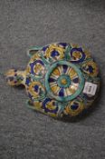 An Islamic pottery pilgrim flask with painted decoration.