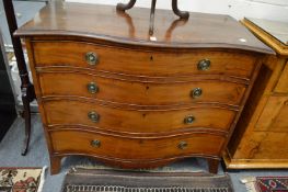 A good George III mahogany serpentine fronted four drawer chest.