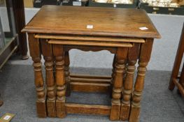 A nest of three oak tables.