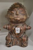 A pre Colombian style painted pottery seated female figure.