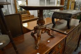 A walnut tripod occasional table.