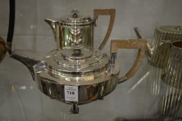 A stylish plated tea pot and matching hot water jug.