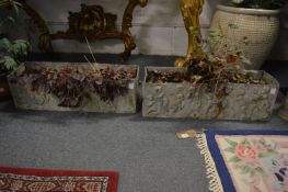 A good pair of lead rectangular troughs decorated with putti.
