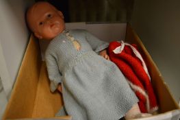 A doll and boxed model cars.