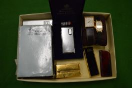 A collection of lighters and his and hers watches.