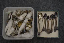 A set of twelve enamel decorated coffee spoons with matching larger spoon and tongs (wear to the