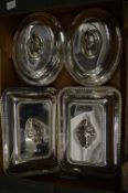 Two pairs of entree dishes and covers.