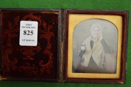 Early photograph of an elderly lady in a leather travelling case.