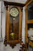 A Victorian walnut cased Vienna wall clock.