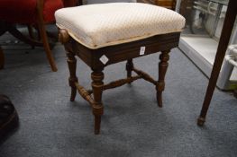 A Victorian walnut adjustable music seat.