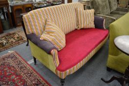 A colourfully upholstered Victorian settee.