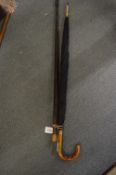 A Gloucester regiment swagger stick, walking stick and umbrella.