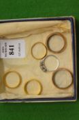 Two 22ct gold wedding bands and four other rings.