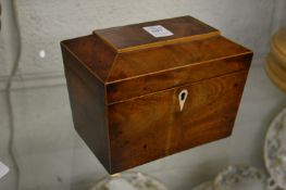 A 19th century mahogany sarcophagus shaped tea caddy.