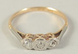 AN 18CT GOLD AND PLATINUM EDWARDIAN THREE STONE DIAMOND RING