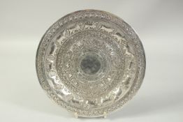 A SRI LANKAN CIRCULAR SILVER DISH decorated with bands of animals. 10ins diameter. Weight: 12ozs.