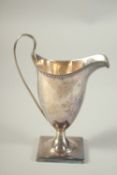 A GEORGE III SILVER HELMET SHAPED CREAM JUG. 5.25ins high. London 1795.
