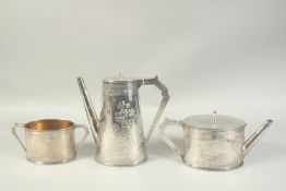 A GOOD ELKINGTON & CO. OVAL SILVER TEA POT , HOT WATER JUG AND SUGAR BASIN with a Chinese design and