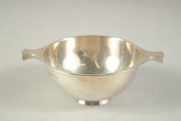 A WALKER AND HALL SILVER CIRCULAR QUAICH. 4ins diameter. Sheffield 1929. Weight: 4ozs.