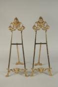 A SMALL PAIR OF BRONZE EASELS. 22ins high.
