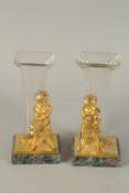 A GOOD PAIR OF GILT BRONZE AND GLASS VASES on Blue John bases with cupids. 9.5ins high.