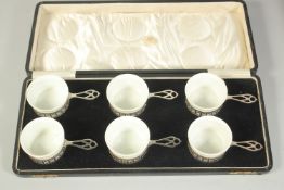 A SET OF SIX GOLDSMITH AND SILVERSMITH CO. SILVER SOUFFLE CUPS with porcelain liners in a fitted