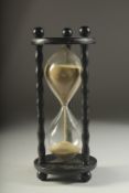 A SAND EGG TIMER. 11 ins high.