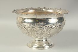 A GOOD CIRCULAR SILVER ROSE BOWL with repousse decoration. 11ins diameter. Sheffield 1926. Maker